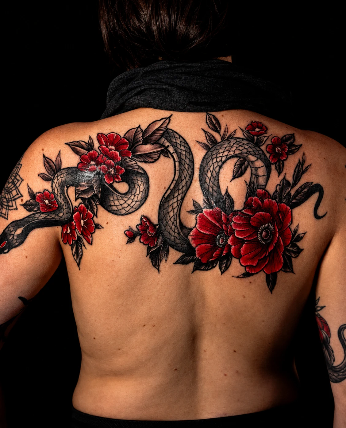 Snakes and red floral back tattoo